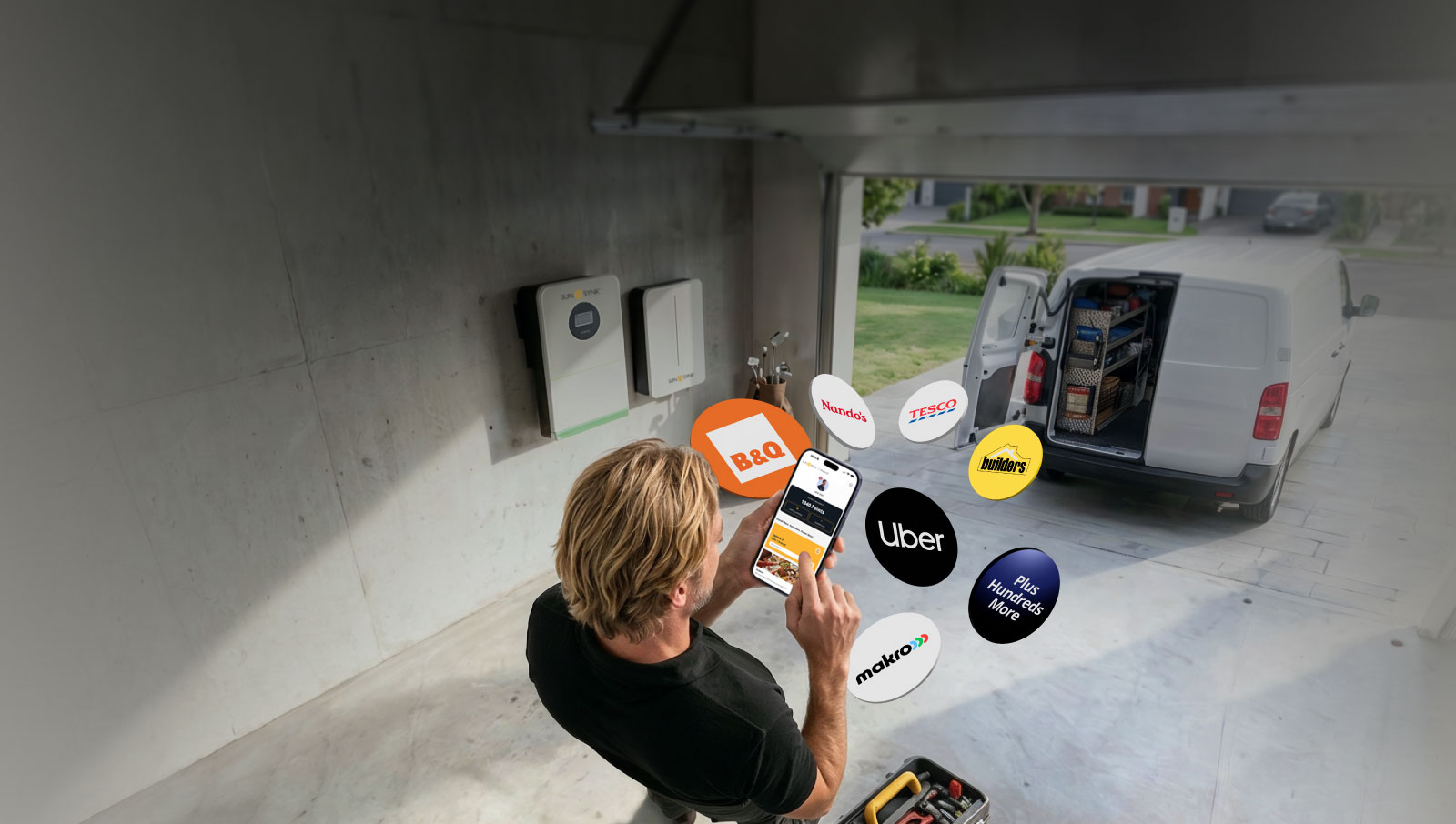 Sunsynk installer standing in a garage. The garage contains a Sunsynk inverter and battery installed on the wall. The installer is checking his phone which shoes the Sunsynk Rewards app, showing the installer how many points he has and where he can spend them.